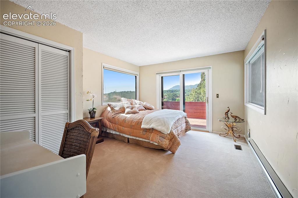 Image 10 of 47: Main level guest bedroom with private deck. (Please do not go out on deck)
