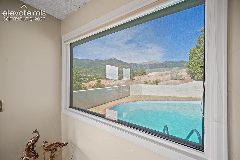 Image 12 of 47: View of the pool from the guest bedroom.