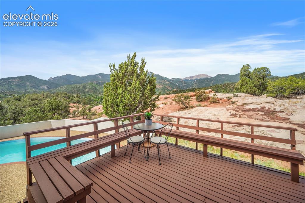 Image 17 of 47: Stunning views of Pikes Peak for the deck that also over looks the pool.
