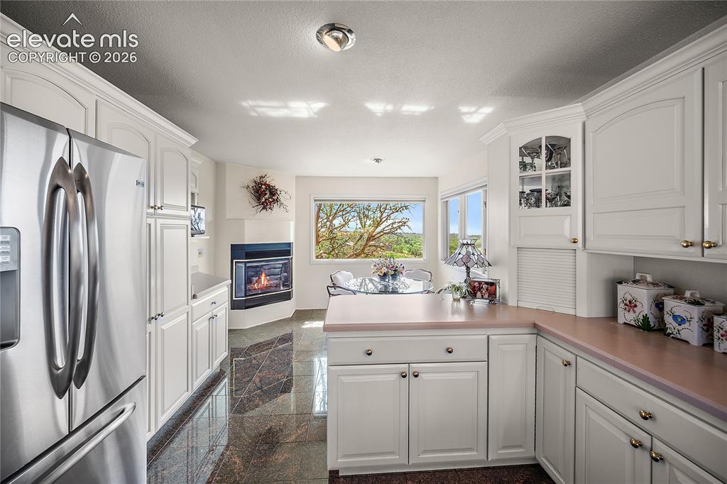 Image 25 of 47: Cozy breakfast nook with gas fireplace and city views.