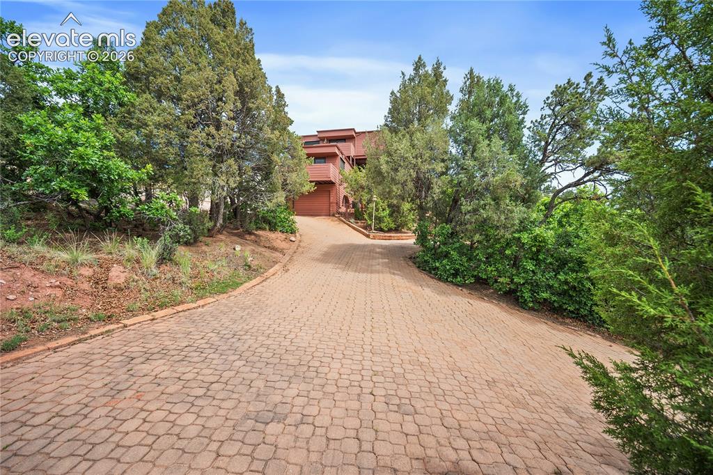 Image 3 of 47: Cobblestone driveway leads to up to the home.