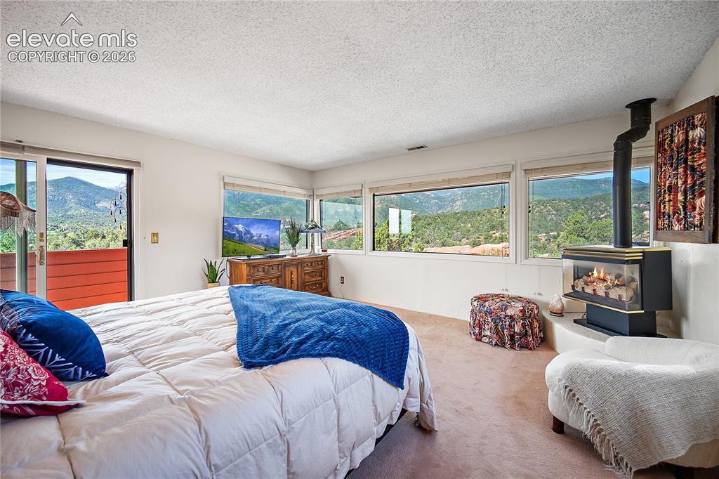 Image 30 of 47: Primary bedroom with private deck, gas stove and VIEWS!