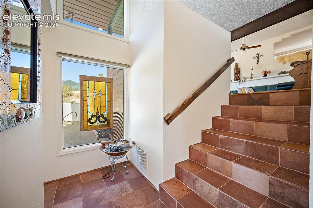 Image 8 of 47: Two story entry with slate tile and tons of natural light.