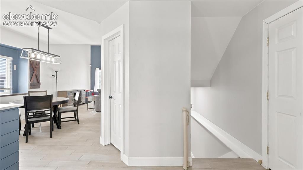 Image 12 of 50: View of the Dining Area and stairs to the Basement.