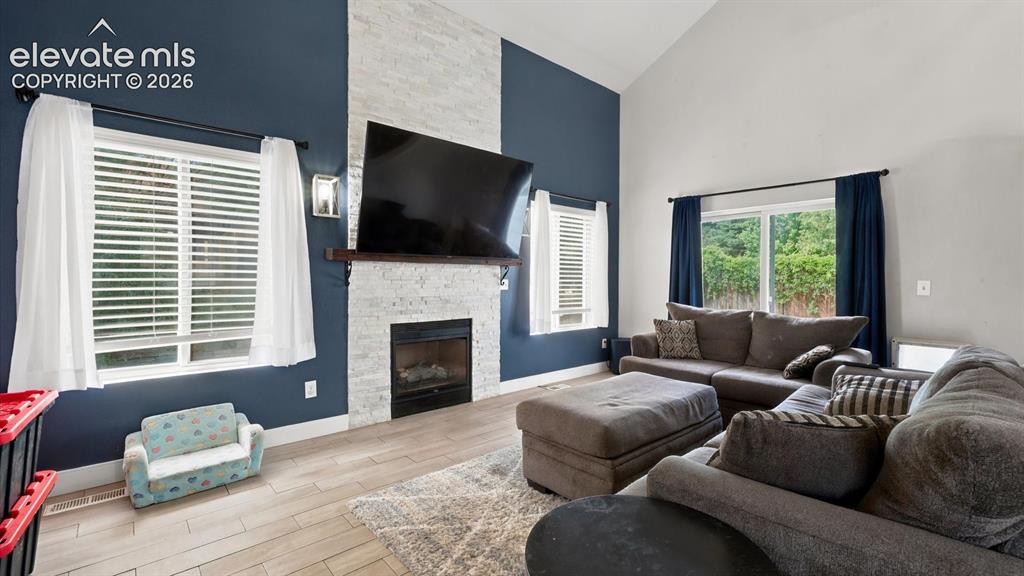 Image 15 of 50: The vaulted Great Room is highlighted by a floor-to-ceiling brick gas firep