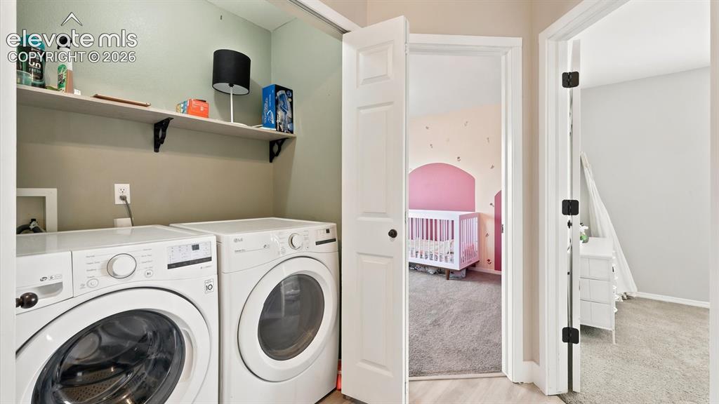 Image 24 of 50: Laundry close with built-in shelf and washer/dryer that stays.