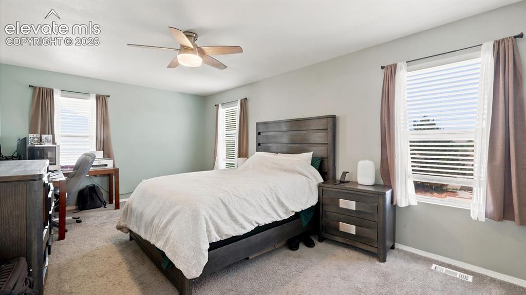 Image 27 of 50: The Primary Bedroom is a private retreat with neutral carpet, a lighted cei