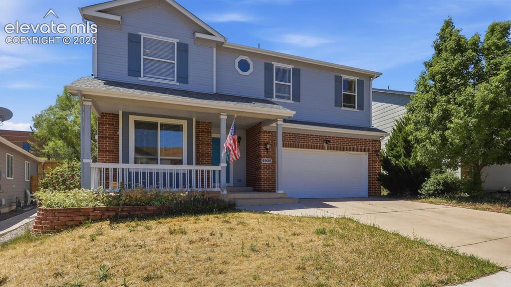 Image 4 of 50: The property features inviting curb appeal with a covered front porch, perf