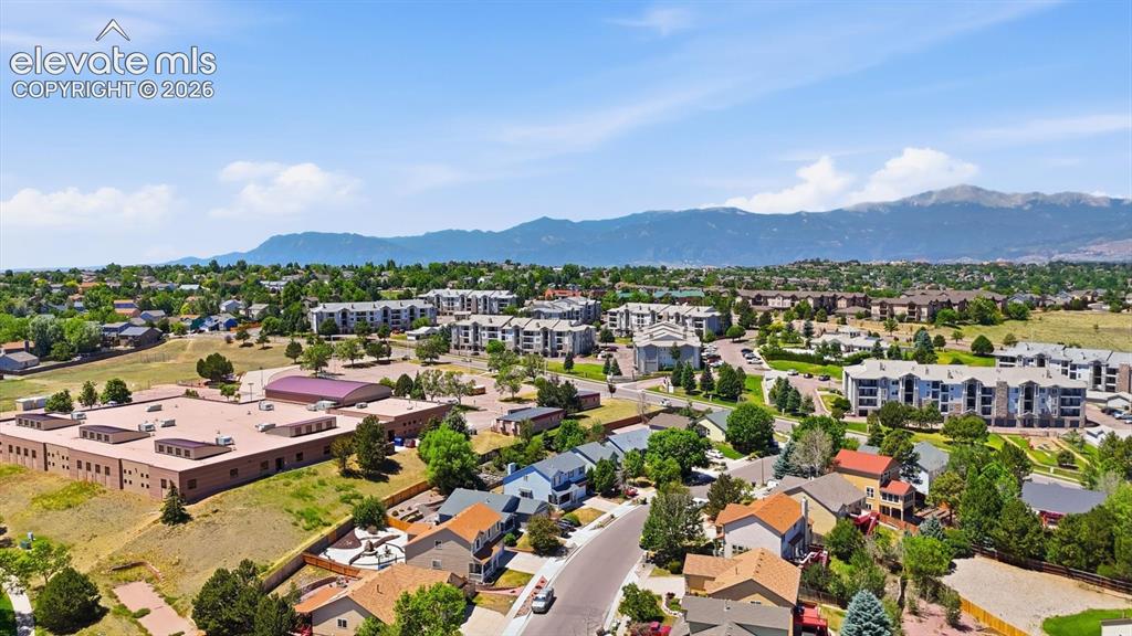 Image 49 of 50: Aerial view of home, school, and mountain views.