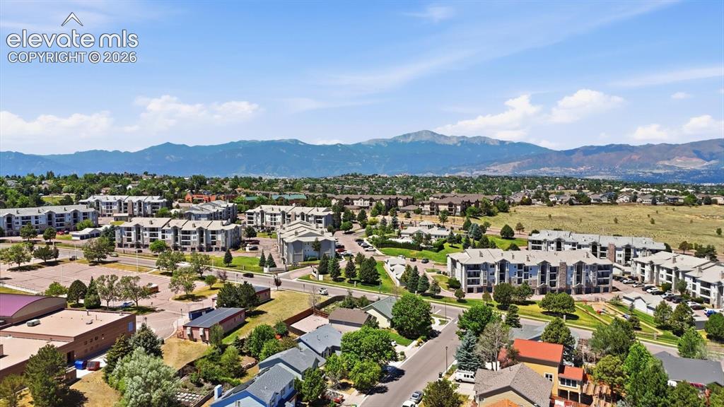 Image 50 of 50: Aerial view of neighborhood with surrounding mountain views.