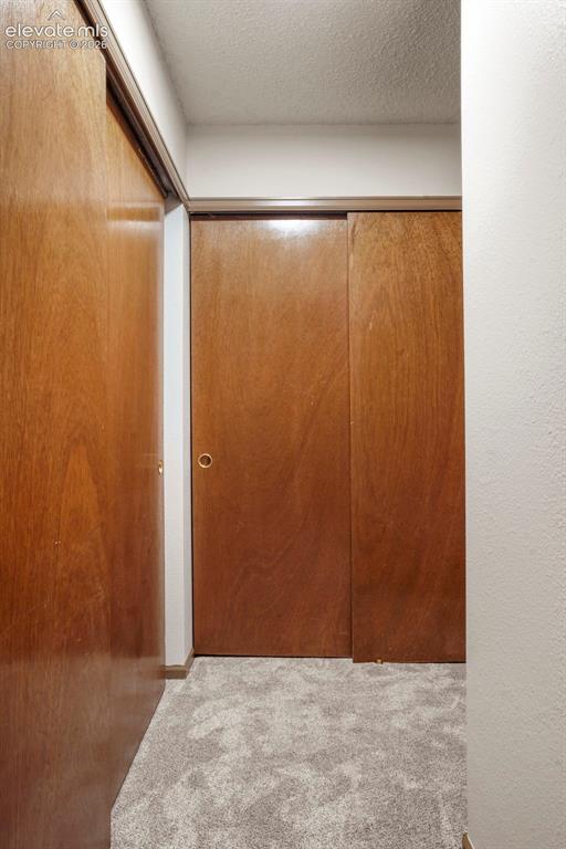 Image 14 of 50: Room details with a textured ceiling and carpet
