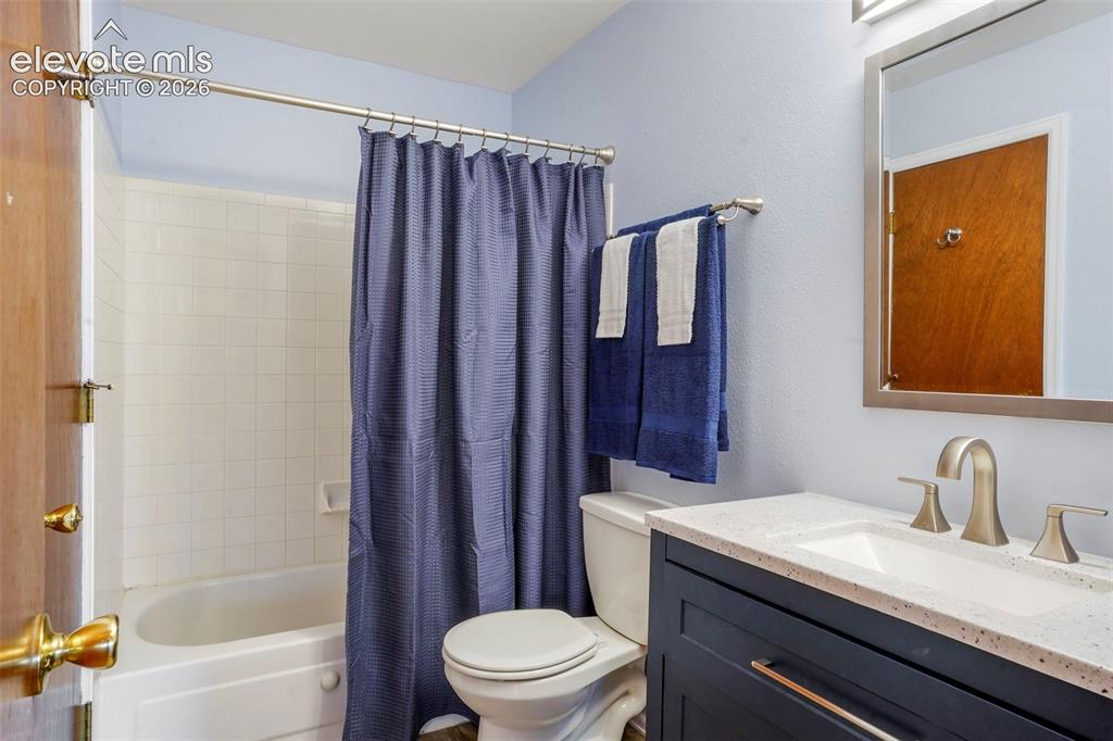 Image 15 of 50: Full bathroom with shower / bath combination with curtain, vanity, and toil