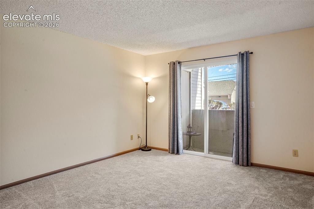 Image 17 of 50: Spare room featuring a textured ceiling and carpet floors