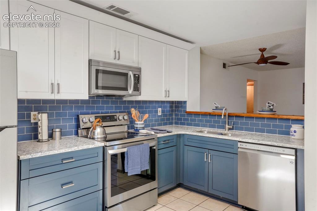 Image 9 of 50: GRANITE, white cabinetry, blue cabinETRY
