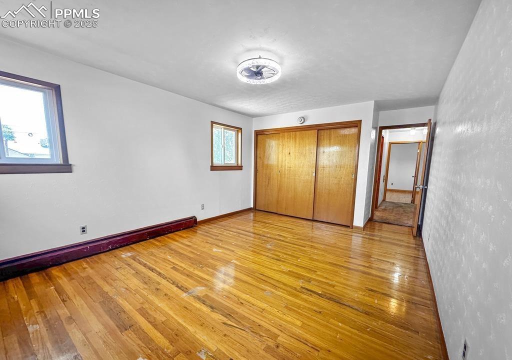 Image 12 of 19: Unfurnished bedroom featuring light wood finished floors and a closet