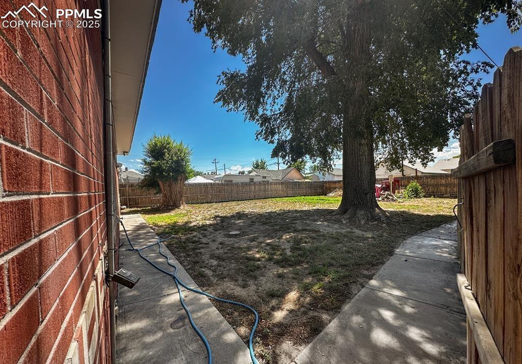 Image 18 of 19: View of fenced backyard