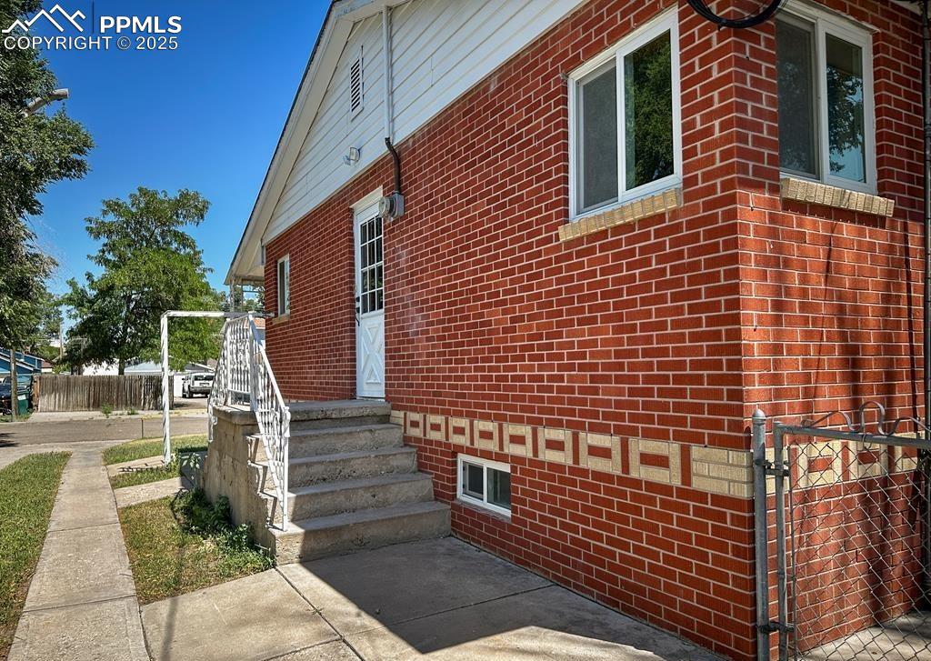 Image 19 of 19: View of property exterior featuring brick siding