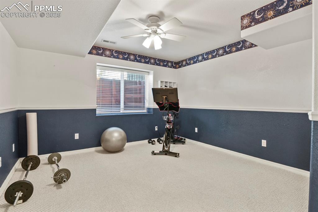 Image 40 of 50: Workout area featuring carpet flooring and ceiling fan