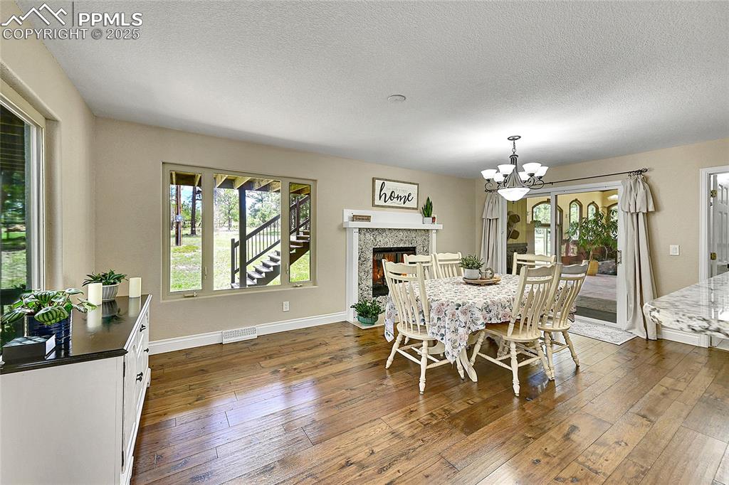 Image 14 of 50: Formal Dining space featuring fireplace and walk out to back deck