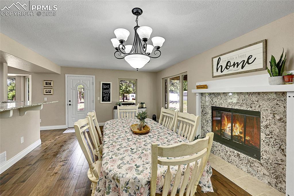 Image 15 of 50: Formal Dining area walk out with fireplace