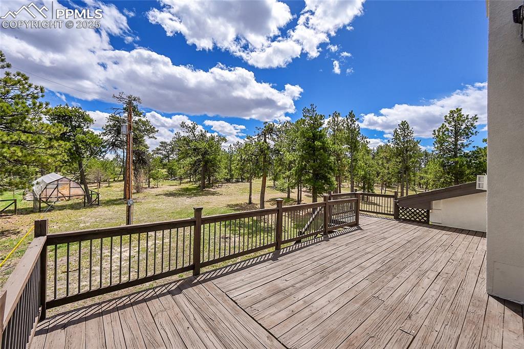 Image 17 of 50: Primary Bedroom private Deck featuring views of pined property