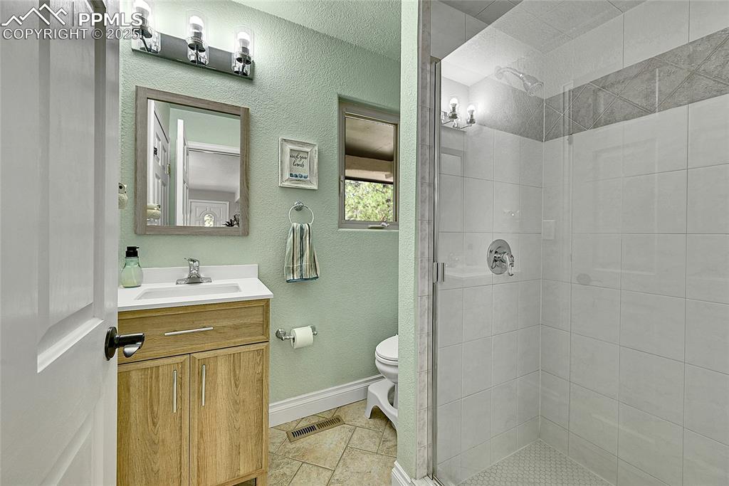 Image 26 of 50: Main level bathroom with shower