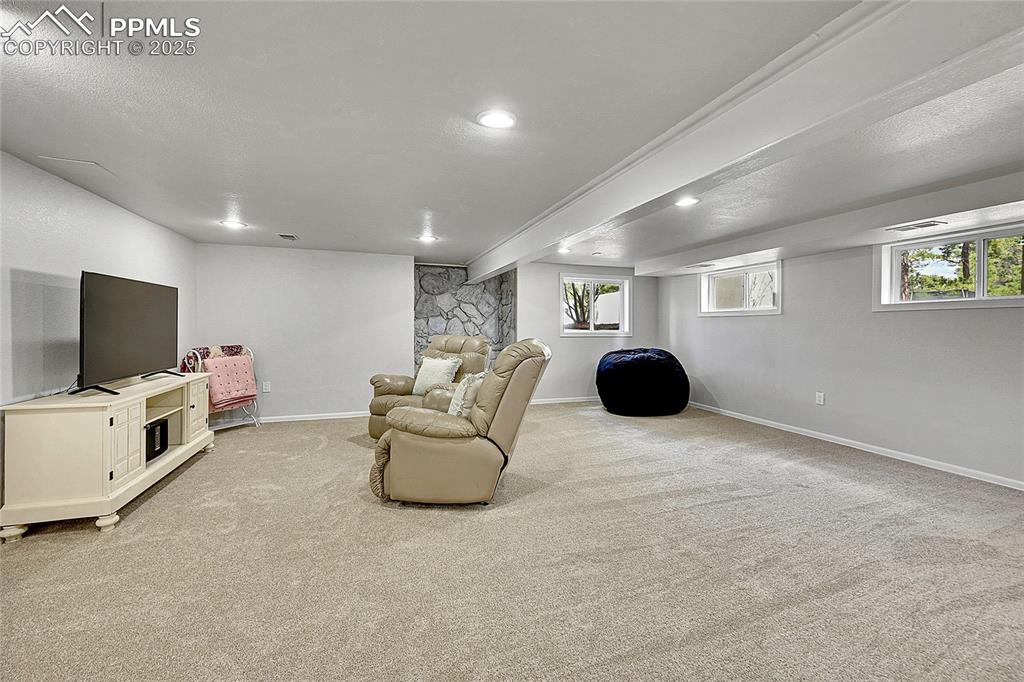 Image 27 of 50: Living room featuring light colored carpet, recessed lighting, baseboards, 