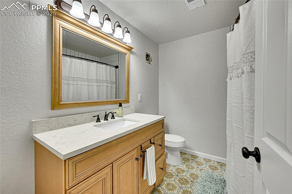 Image 29 of 50: Full bathroom featuring new tile floor and in shower