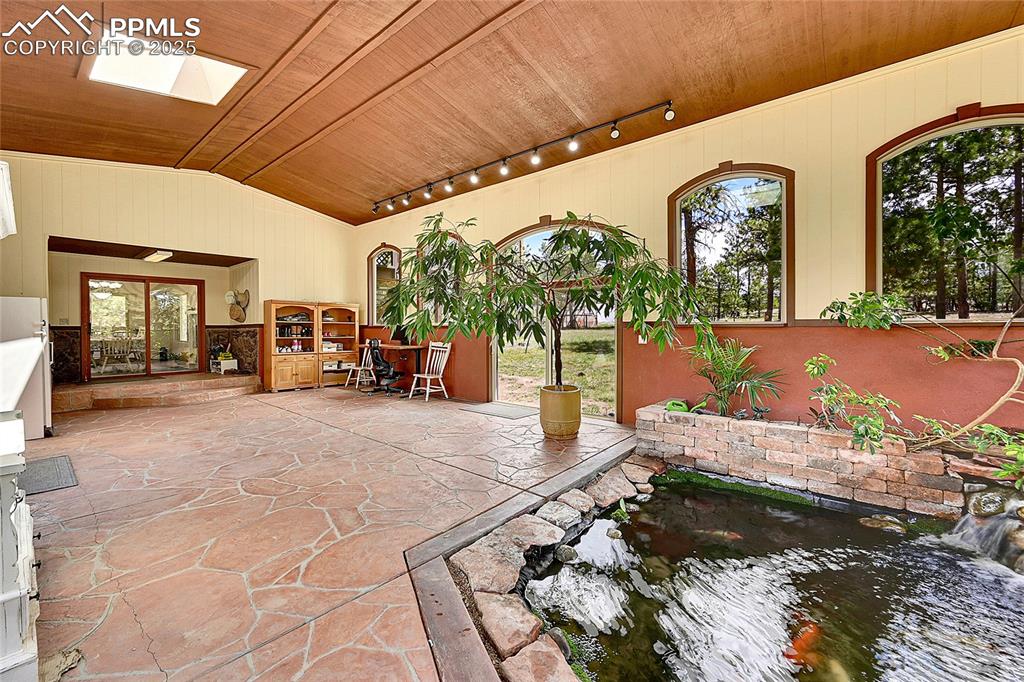 Image 33 of 50: main level abundant light new stain on ceiling and trim. 