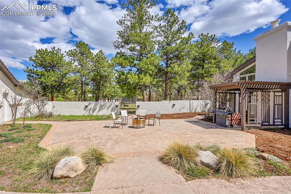 Image 36 of 50: oversized patio, pergola, outdoor fire pit