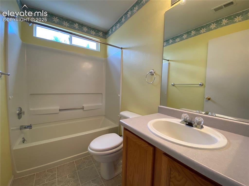 Image 6 of 9: Full bathroom featuring a combined shower and tub with a high transom windo