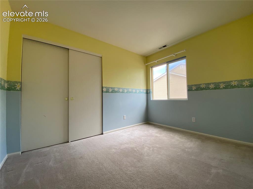 Image 7 of 9: Plush neutral carpeting extends across the floor