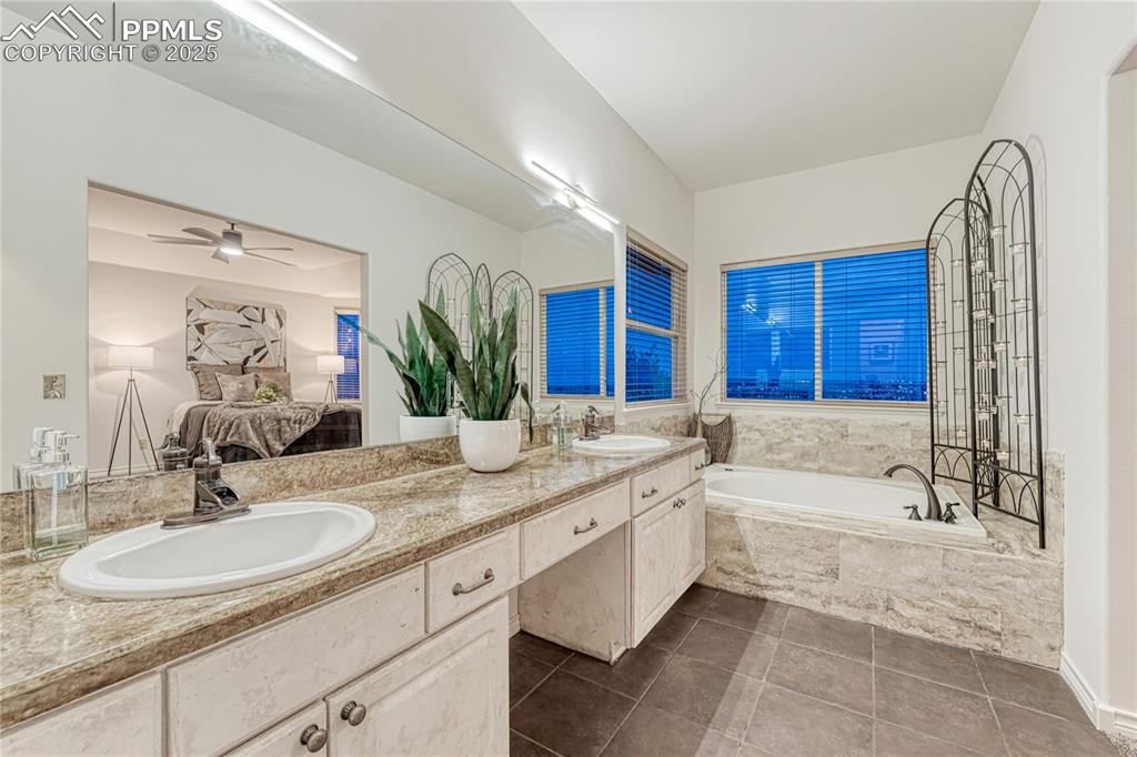 Image 15 of 28: The views from this main floor primary bedroom & bathroom ever night- with 