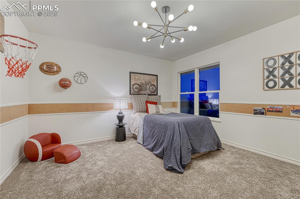 Image 19 of 28: Upper level bedroom looking out to the city lights and scrub oak thicket be