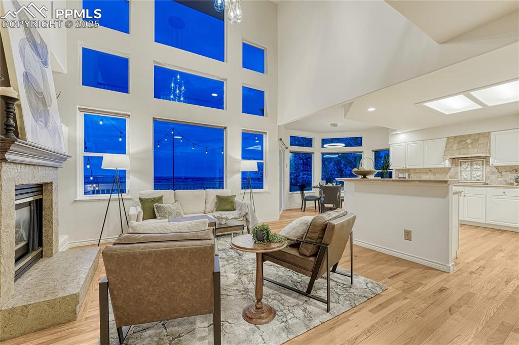 Image 2 of 28: The Living room/kitchen area has a city lights view from Black Forest to Se