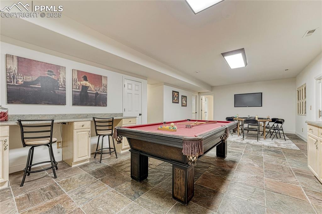 Image 24 of 28: This lower level room walks out to the patio & backyard. The far end shows 