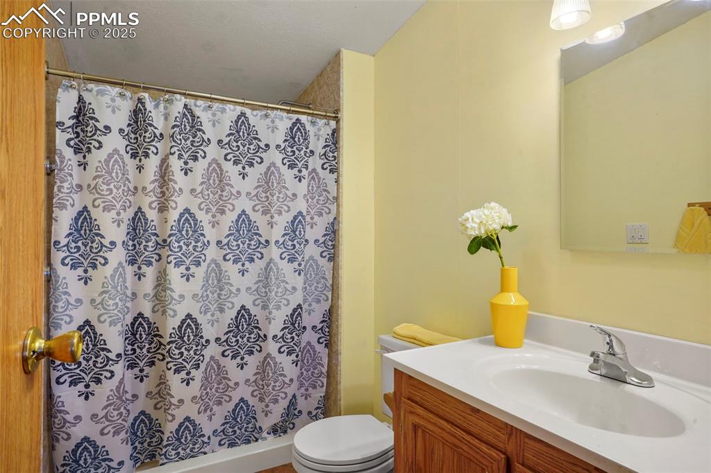 Image 16 of 29: Full bath with vanity and a stall shower