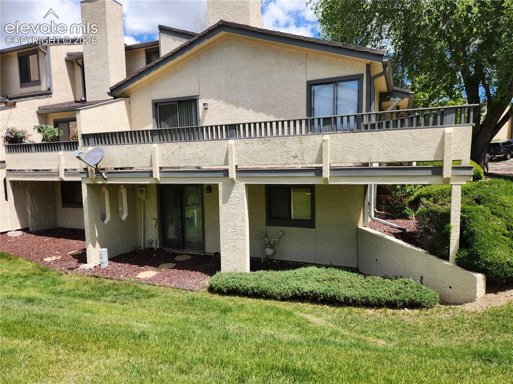 Image 2 of 25: Back of Townhome, with walk out Basement and Upper Deck