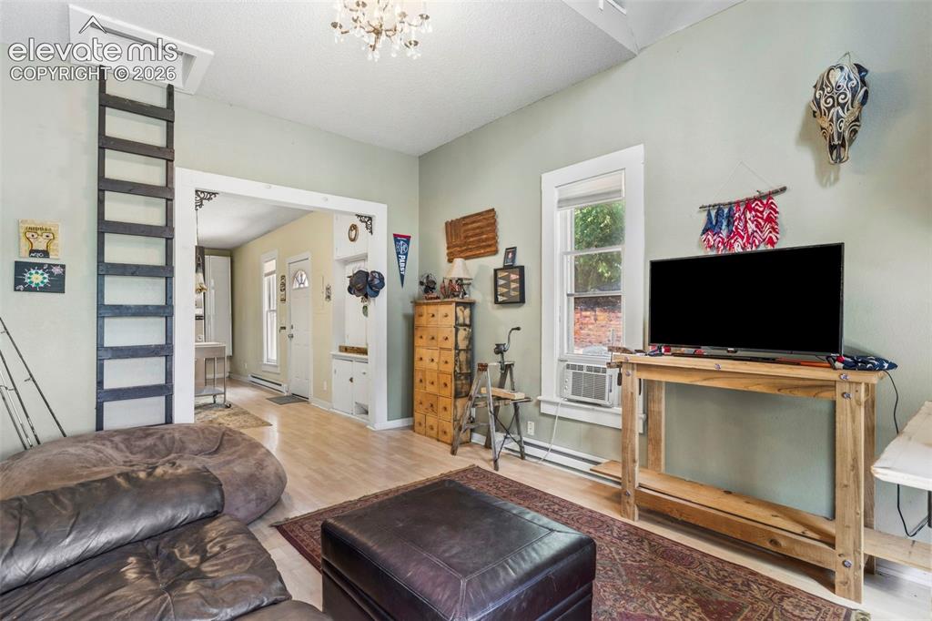 Image 13 of 25: A spacious living room with an open concept flows seamlessly into the kitch