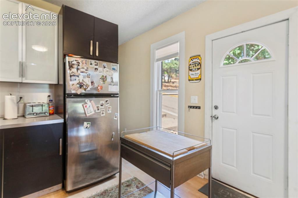 Image 5 of 25: A modern industrial-style kitchen with wood-laminate flooring