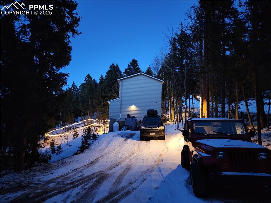 Image 27 of 37: Snowy night view from the driveway.