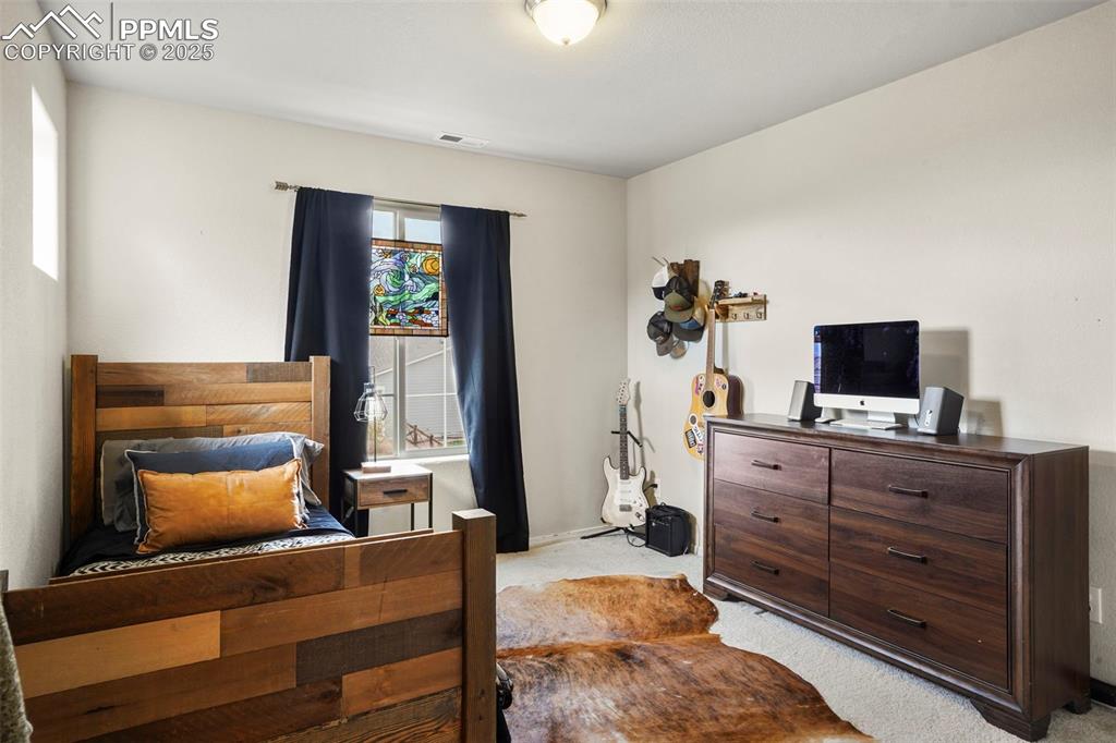 Image 16 of 36: Upper Level Front Bedroom with views of Pikes Peak