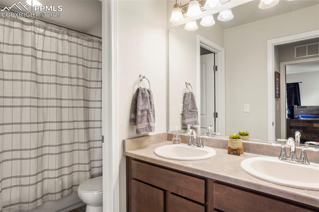 Image 18 of 36: Upper level Bathroom featuring a double vanity