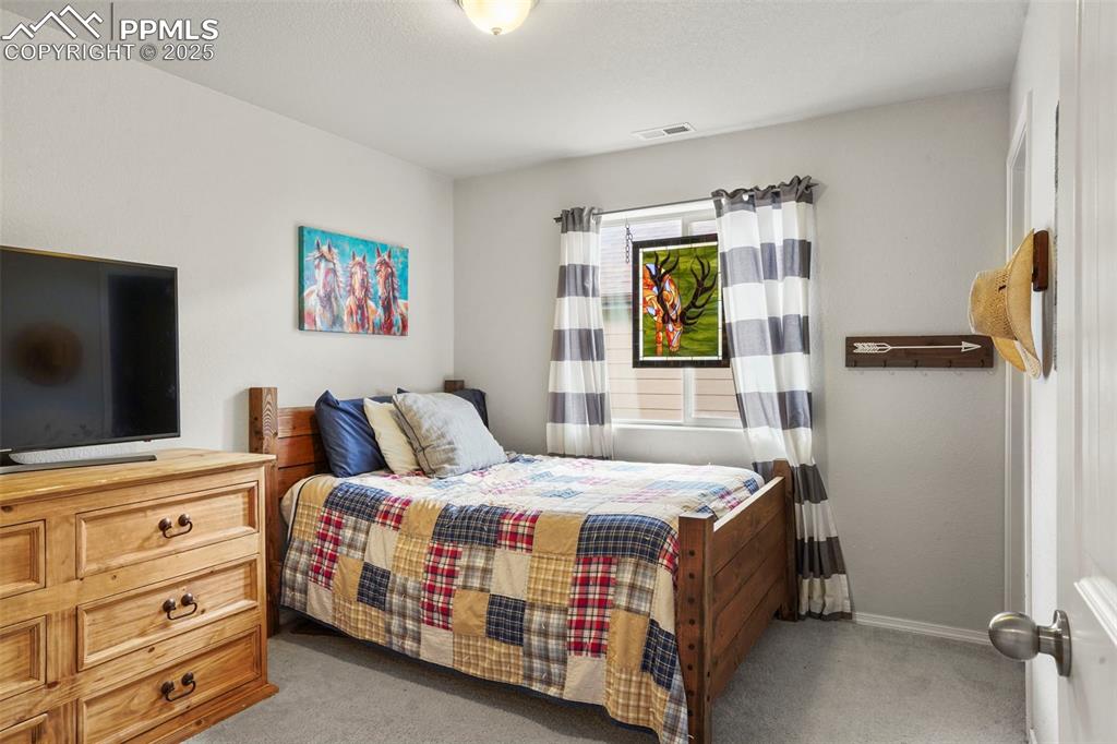 Image 19 of 36: Upper Level bedroom