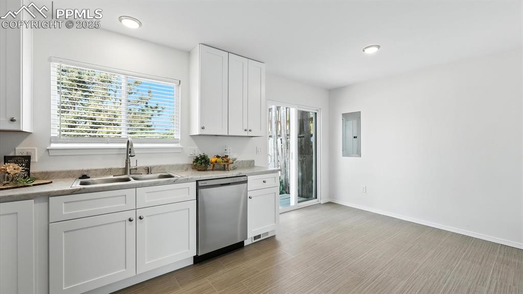 Image 18 of 50: Kitchen into the Dining Area with LVP floor and slider to the back of the u
