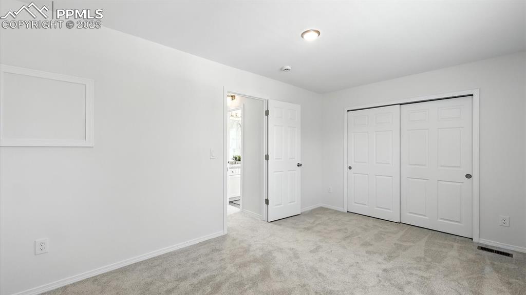 Image 32 of 50: Upper Level Bedroom #2 provides a generous closet for wardrobe storage.