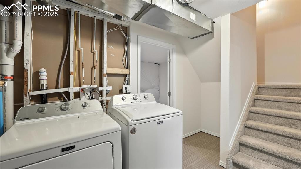 Image 34 of 50: Partially finished Basement with Laundry Room that includes a washer and dr