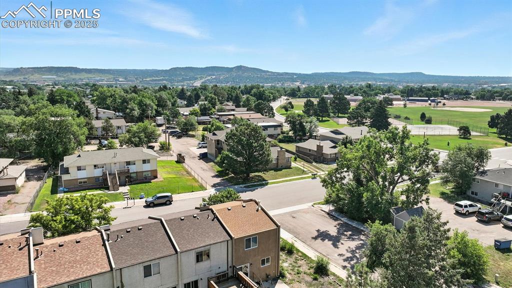 Image 49 of 50: Aerial view of home and neighborhood with mountain views in the distance.