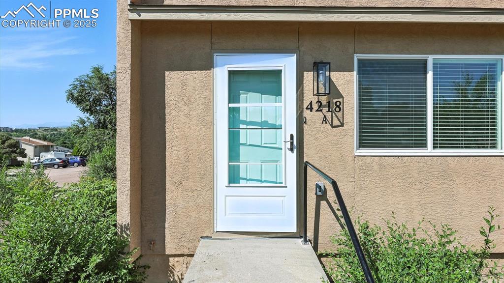 Image 7 of 50: Concrete walkway up to the storm door entry.