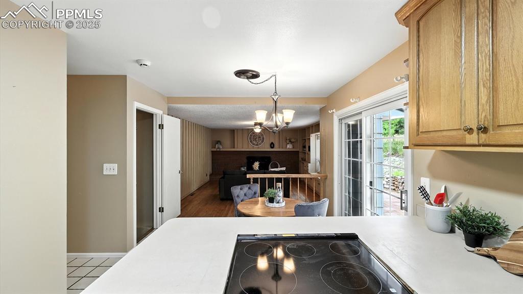Image 15 of 50: View into the Dining Nook and Family Room from the Kitchen.